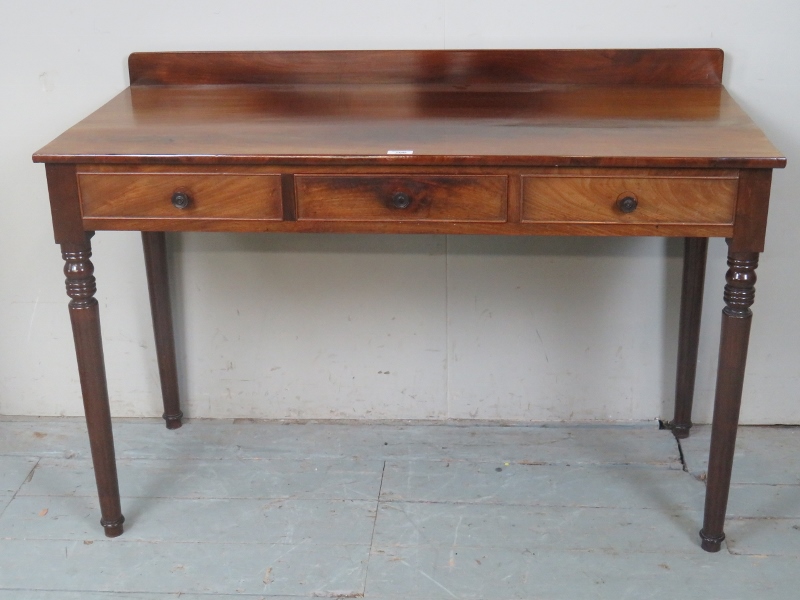 An Edwardian mahogany hall table with three frieze drawers over turned legs est: £40-£60