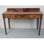 An Edwardian mahogany hall table with three frieze drawers over turned legs est: £40-£60