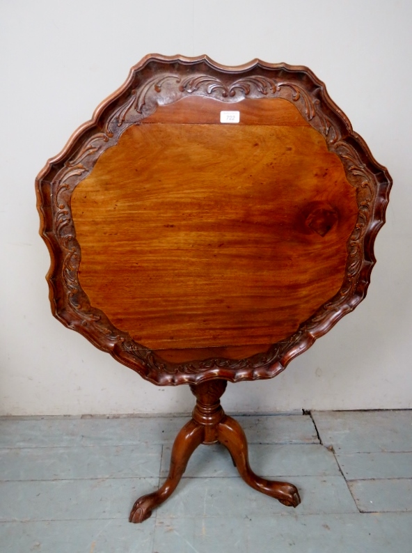 A 19th Century walnut pie crust tilt top table with a carved column and triple splayed legs est: