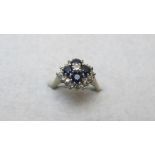 A white gold diamond and sapphire cluste