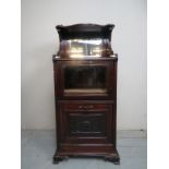An Edwardian mahogany music cabinet with