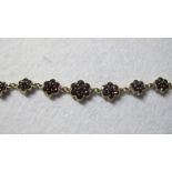 A 14ct gold and garnet bracelet, forming