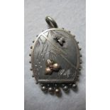 An unmarked Victorian locket with engrav