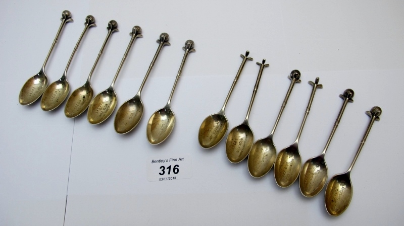 A set of 12 silver 'golfing' teaspoons w