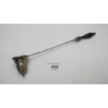 A sterling silver candle snuffer with wo