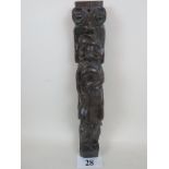 A 17th/18th century carved oak column depicting a male figure with bagpipes,