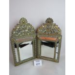 A pair of 19th century embossed brass framed ornate wall mirrors,