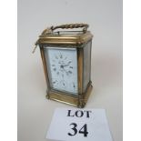 A fine quality carriage clock by L'Epee with repeater chime button, day, date and alarm dials,