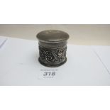 An embossed silver box with angel decoration,