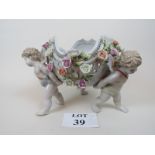 Decorative German porcelain reticulated table centre-piece with cherubs carrying a bowl decorated