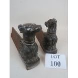 A pair of late 19th / early 20th century cast metal fire dogs with dog's head and anthemion leaf