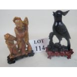 An early 20th century Chinese carved soapstone figure group, on shaped wooden stand, 17 cm high,