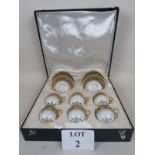A decorative early 20th century French cased set of six porcelain cups and saucers,
