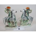 A rare pair of 19th century Staffordshire pottery zebra & snake spill vases, 21 cm high,
