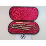 A Victorian cased set of silver plated nut crackers, silver plated grape scissors,