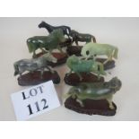 A group of eight early 20th century Chinese carved jade horses, on shaped wooden stands,