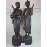 A pair of large and decorative eastern carved hardwood figures, depicting native men,