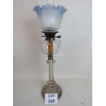 A Victorian clear glass oil lamp with etched and coloured shade,