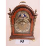 A good quality Junghans Georgian-style walnut cased bracket clock with gilt-metal mounts and arched