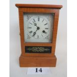 A 19th century American mantel clock, with reverse painted glass panel door, printed paper interior,