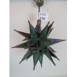 A vintage star shaped brass and coloured