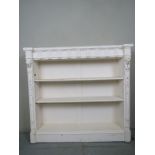 A white painted open bookcase with carve