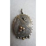 An unmarked Victorian locket with engrav