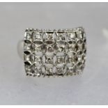 AN ART DECO STYLE DIAMOND CLUSTER RING, believed 18ct white gold set, size K and half