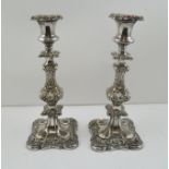 A PAIR OF 19TH CENTURY OLD SHEFFIELD PLATE CANDLESTICKS, having embossed knop stem design with lobed