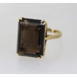 A LADY'S 9CT GOLD RING SET set with large smoky quartz, size Q