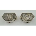 TWO EUROPEAN WHITE METAL SNUFF BOXES having embossed cherub and classical figure decoration,