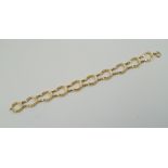 A 9CT GOLD BRACELET with 10 horse-shoe links and bolt ring clasp, 9g