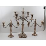 A 20TH CENTURY SILVER PLATED TABLE CANDELABRA, the central nozzle surrounded by four scrolling arms,
