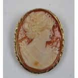 A 9CT GOLD FRAMED CAMEO BROOCH depicting a lady of fashion profile portrait, 4cm high