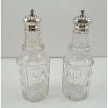 A PAIR OF VICTORIAN SILVER MOUNTED CUT GLASS CONDIMENT BOTTLES, Sheffield 1844, 15cm high