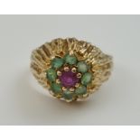 A 9CT GOLD EMERALD AND RUBY CLUSTER RING, having small central ruby surrounded by eight emeralds,