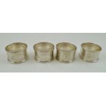 ISRAEL SIGMUND GREENBERG A SET OF FOUR SILVER NAPKIN RINGS, each with banded decoration, each