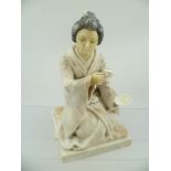 A JAPANESE ALABASTER KNEELING GEISHA GIRL, performing the tea ceremony, 20cm high