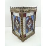 AN EDWARDIAN BRASS FRAMED HALL LANTERN, inset four leaded panels of stained and moulded glass,