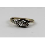 A THREE STONE DIAMOND RING, brilliant cut, set in a platinum mount, on 9ct band, ring size K 1/2