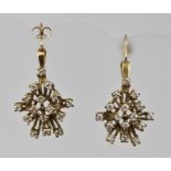 A PAIR OF 9CT GOLD DIAMOND SET EARRINGS of contemporary "starburst" design