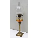 A LATE VICTORIAN BRASS CORINTHIAN COLUMN OIL LAMP with clear glass reservoir and decorative etched