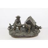 A LATE 19TH CENTURY BRONZE NOVELTY INKWELL, cast as a boy feeding a dog emerging from his kennel,