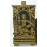 AN EARLY 20TH CENTURY INDIAN CARVED HARDWOOD PANEL, considered to depict "Krishna" seated upon a