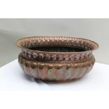 A LATE 19TH CENTURY EMBOSSED COPPER PLANTER OR WINE COOLER, of oval form with turn-over rim, 52cm