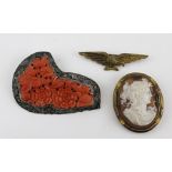 A CHINESE BROOCH, floral carved coral in a silver filigree frame, together with an EAGLE PIN