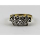 A LADY'S DIAMOND SET RING, having a central run of five graduated stones, flanked by eight others,