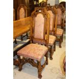 A SET OF EIGHT OAK FRAMED DINING CHAIRS each with carved crest, upholstered seat and back pad,