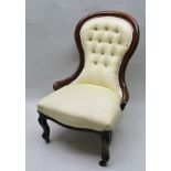 A VICTORIAN MAHOGANY SHOW WOOD FRAMED BUTTON BACK NURSING CHAIR, raised on cabriole fore supports,