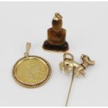 A 9CT GOLD DOG MOUNTED STICK PIN, having stone set eyes, together with a 9ct gold PENDANT MOUNTED